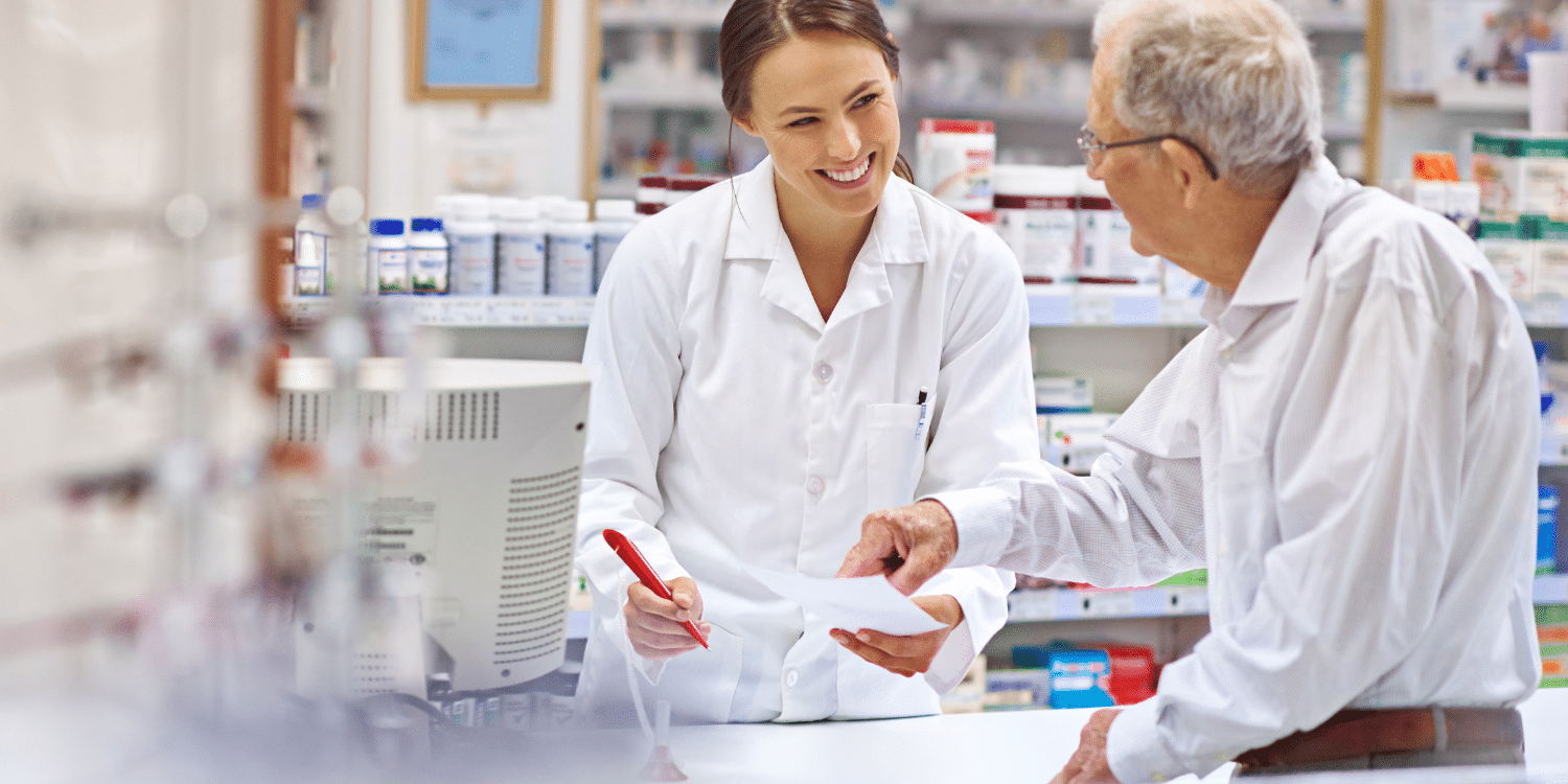 Pharmacy-Assistant-helping-elderly-patient-read-medication-list